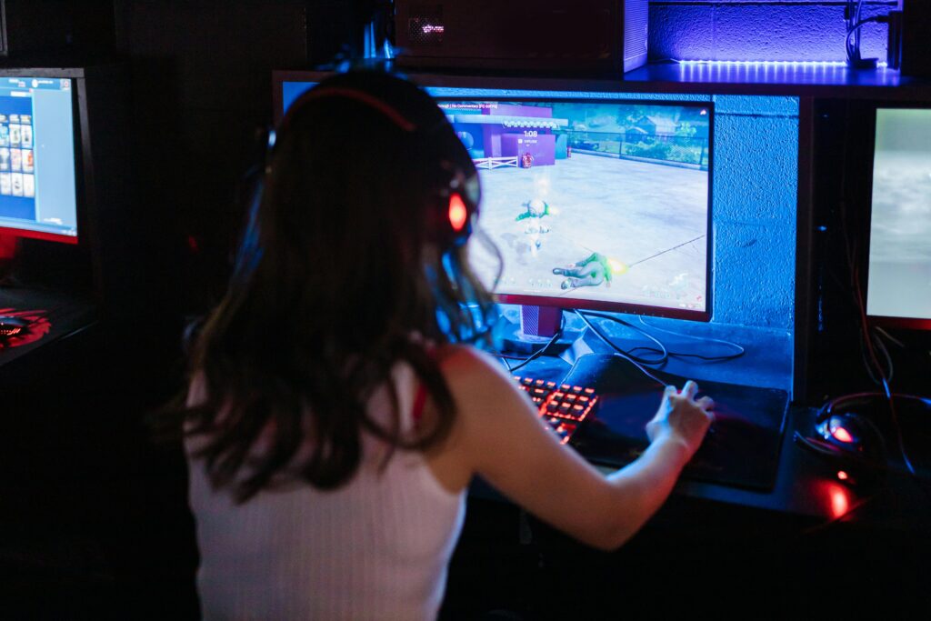 A girl gamer playing competitive games on a monitor 